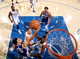 NBA赛场俯拍视角，球员在蓝色地板上奔跑争抢篮球